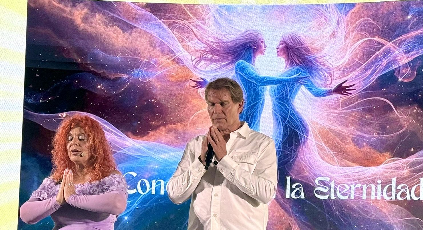 Núria López y Pere Pascuet, escritores angelólogos, en meditación durante una conferencia espiritual sobre ángeles.